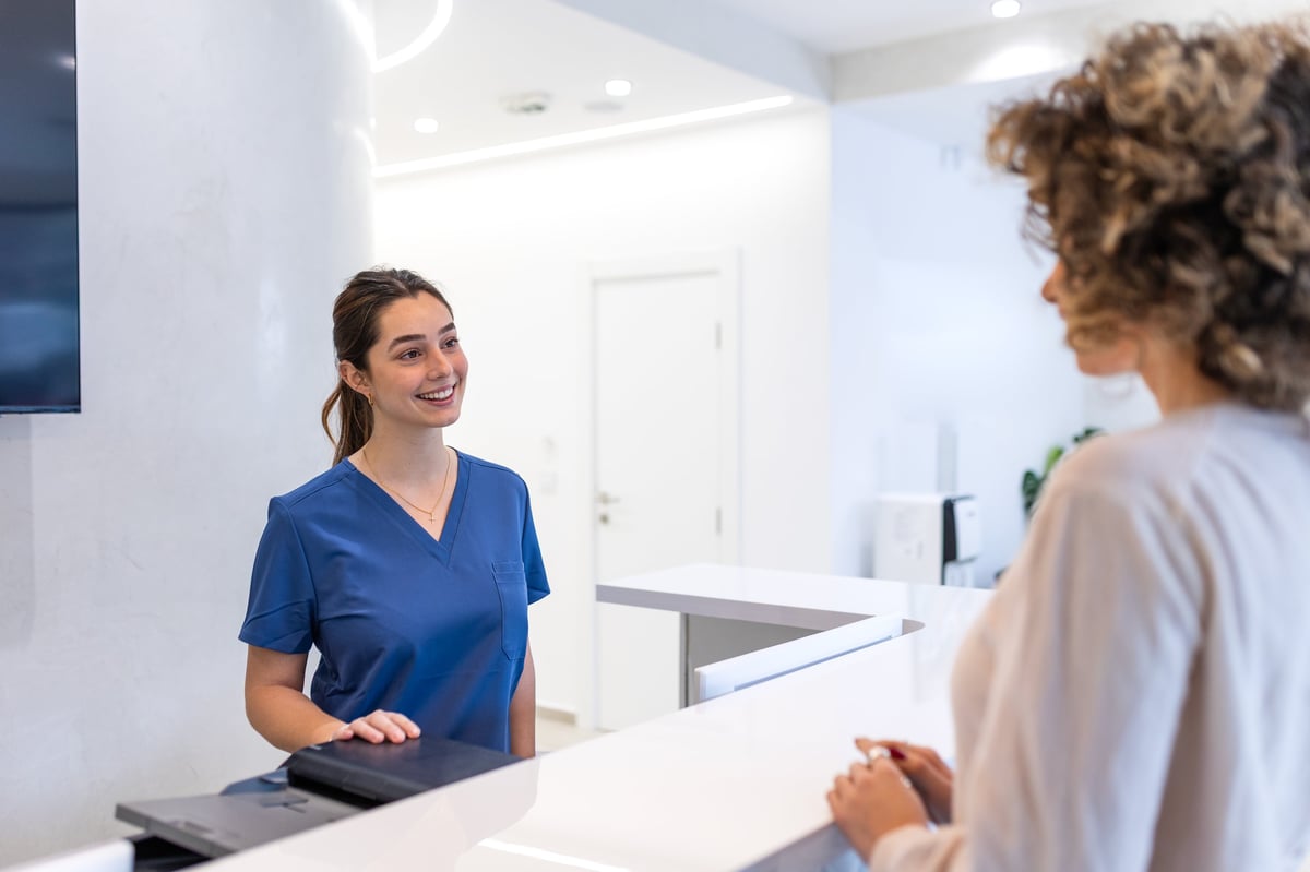 Busy medspa front desk coordinator managing a full reception area